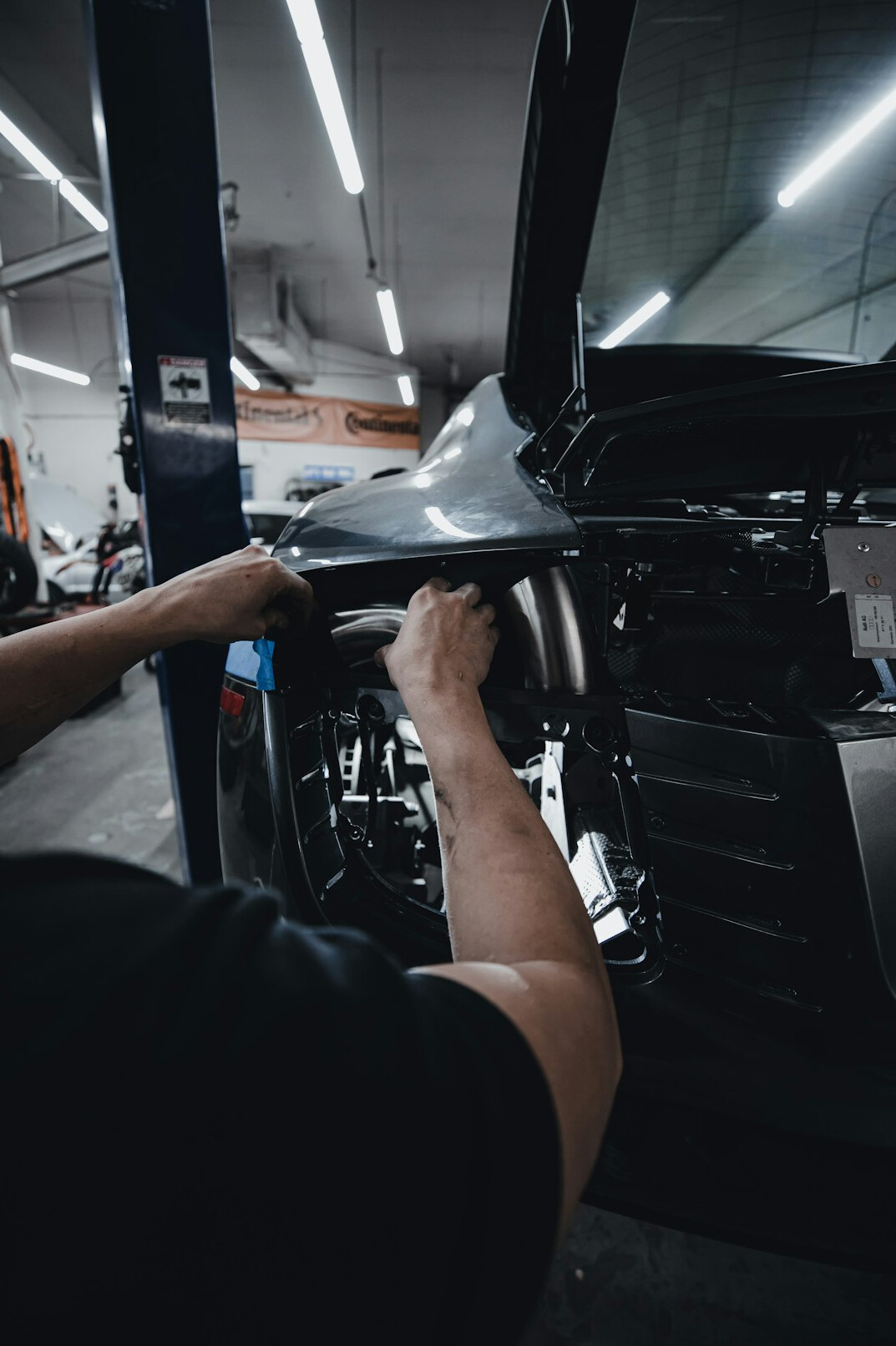 Technician carefully working on a vehicle