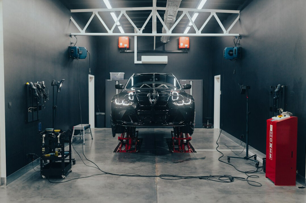 Clean auto workshop with a car on a lift